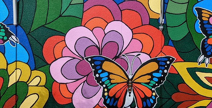 mural featuring colourful painted flowers and butterflies
