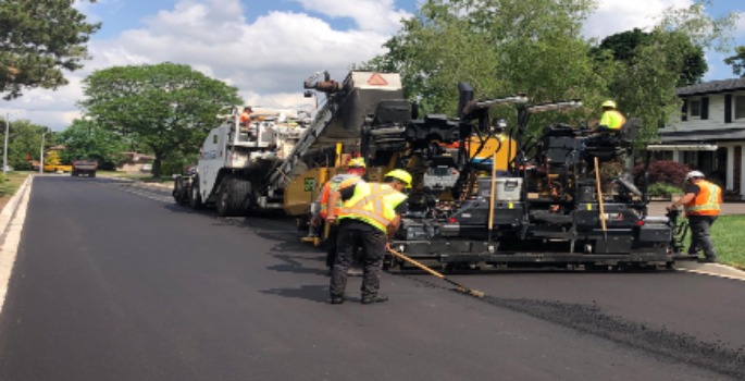 Crew repaving road