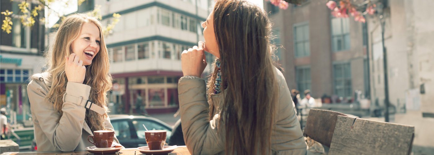 Two young women enjoying an outdoor patio