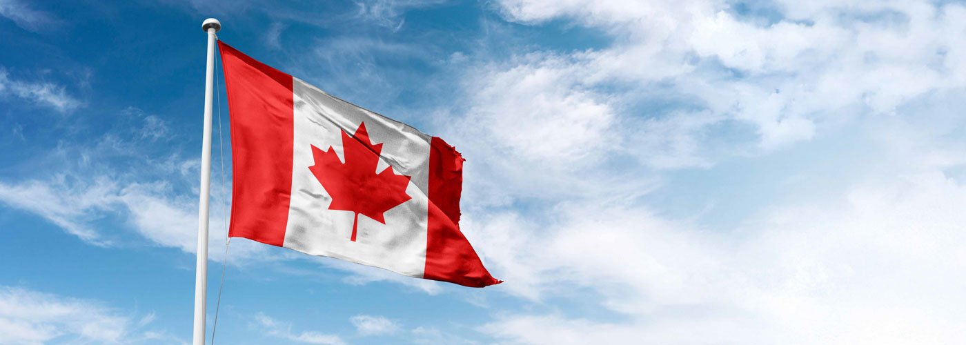 Banner - Standing up for Canadian businesses Canadian flag waving in blue skies