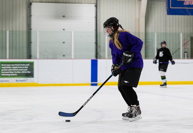 Passes and memberships Woman playing shinny hockey